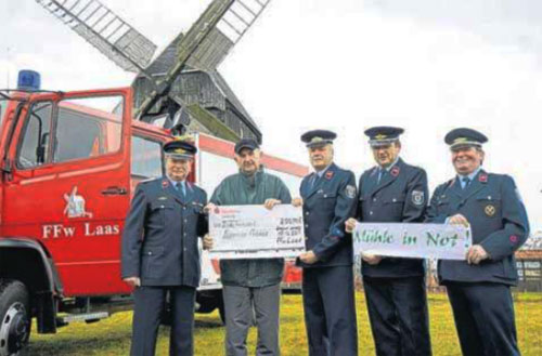 Horst Hanke (zweiter von links) nimmt den Scheck �ber 200 Euro von den Kameraden der Freiwilligen Feuerwehr Laas zur Rettung der M�hle entgegen. Foto: Thomas Barth